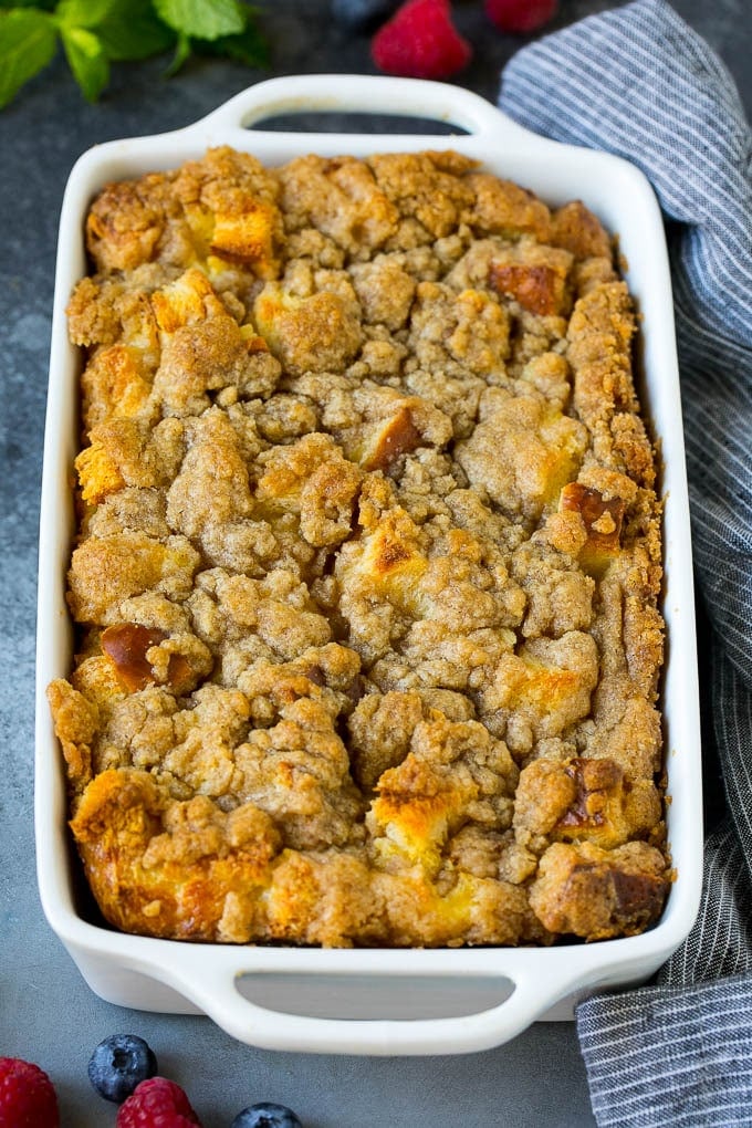 French Toast Casserole Recipe | French Toast Bake #frenchtoast #casserole #breakfast #brunch #sadud #bread A dish of french toast casserole topped with brown sugar streusel.