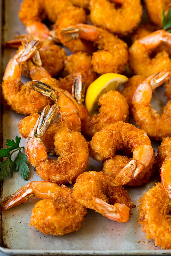 Fried Shrimp Recipe #shrimp #seafood #dinner #appetizer #sadud Fried shrimp on a sheet pan garnished with parsley and lemon.