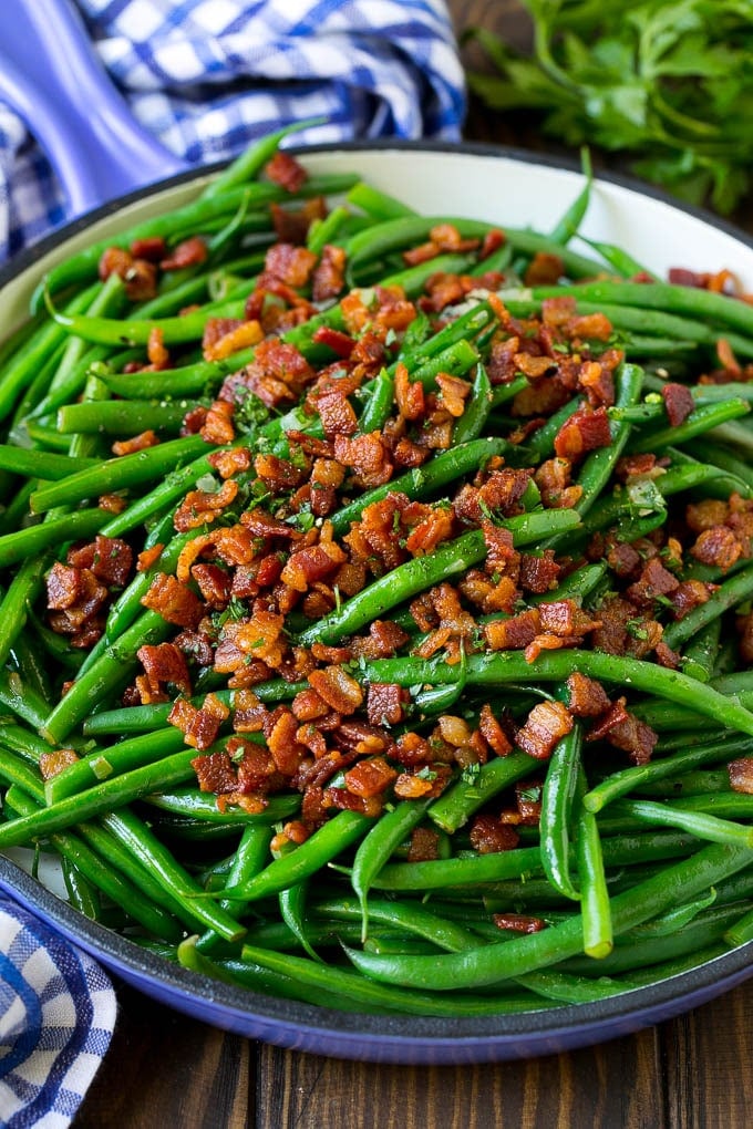Green Beans with Bacon Recipe | Bacon Green Beans #bacon #greenbeans #sidedish #thanksgiving #veggies #dinner #sadud Green beans with bacon in a skillet, topped with parsley.