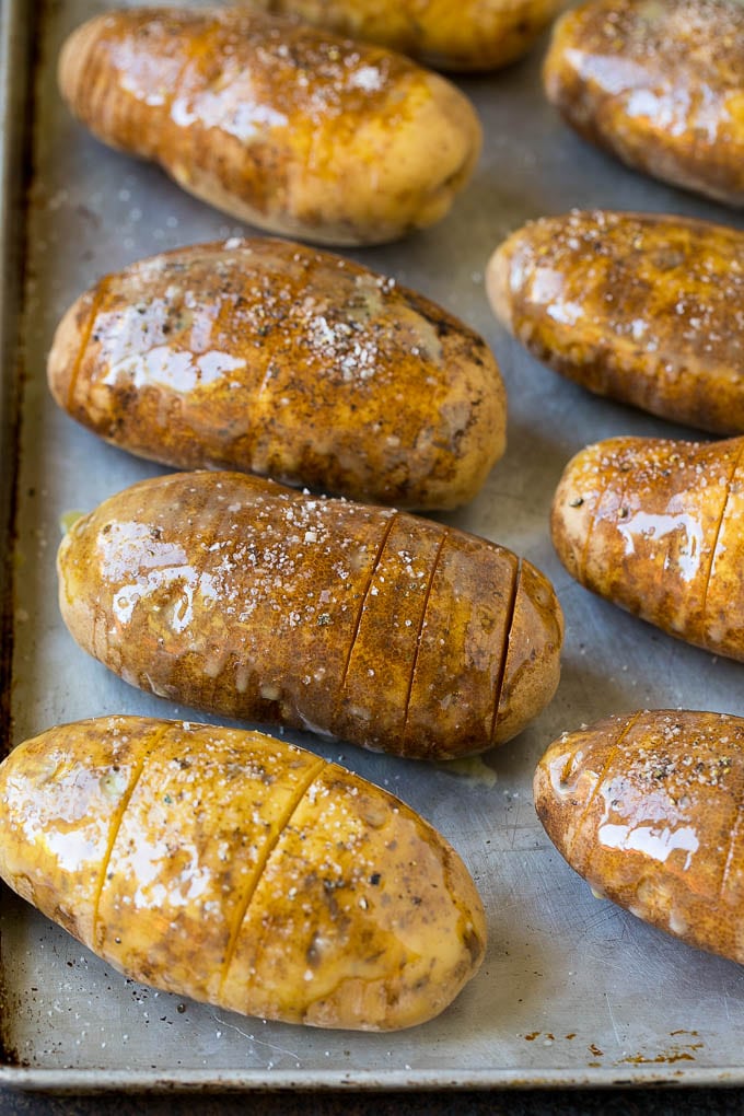 Hasselback Potatoes Recipe #potatoes #bacon #sidedish #cheese #dinner #sadud Potatoes on a sheet pan coated in olive oil and butter.