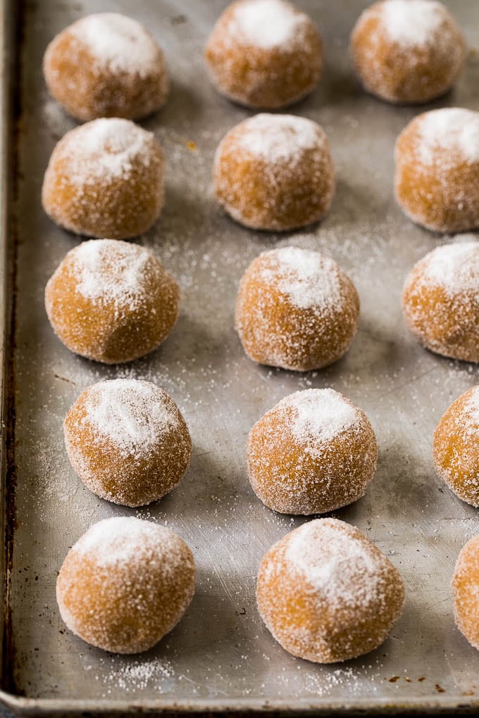 Molasses Cookies Recipe | Spice Cookies #cookies #baking #christmas #dessert #sadud Balls of cookie dough rolled in sugar on a sheet pan.