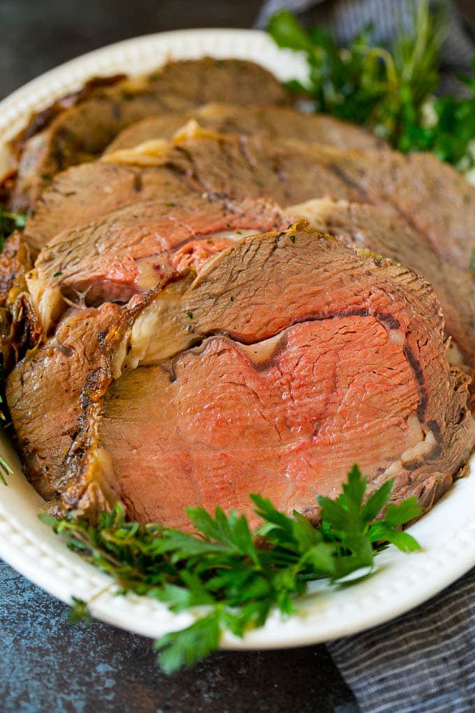 Prime Rib Recipe #primerib #beef #roast #dinner #thanksgiving #christmas #keto #lowcarb #sadud Sliced slow roasted prime beef on a serving platter.
