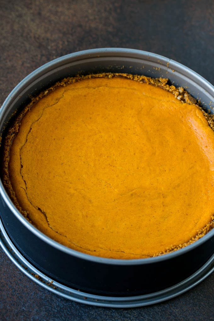 Pumpkin Pie Cheesecake Recipe | Pumpkin Cheesecake #cake #cheesecake #pumpkin #fall #thanksgiving #dessert #sadud A baked pumpkin cheesecake in a pan.