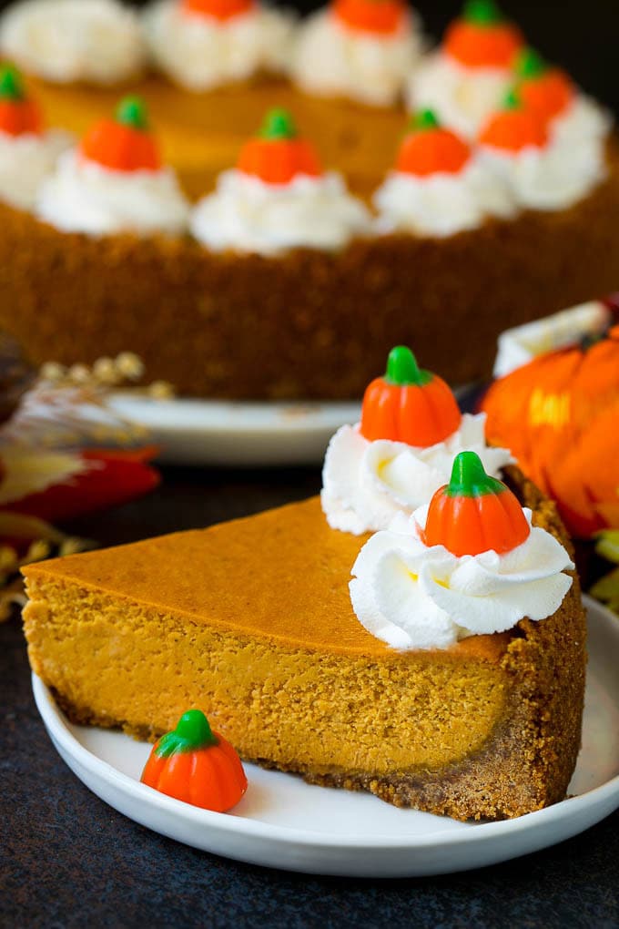 Pumpkin Pie Cheesecake Recipe | Pumpkin Cheesecake #cake #cheesecake #pumpkin #fall #thanksgiving #dessert #sadud A slice of pumpkin pie cheesecake garnished with whipped cream.