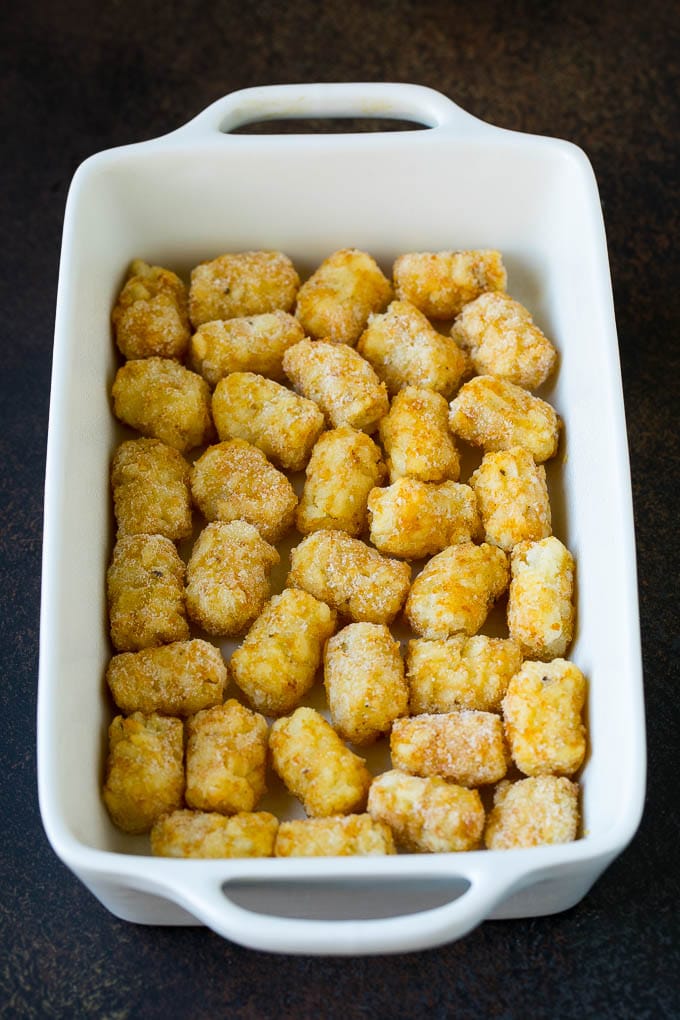 Sausage Egg Casserole Recipe | Egg Casserole #eggs #sausage #potato #cheese #casserole #breakfast #brunch #sadud Potato tots in a casserole dish.