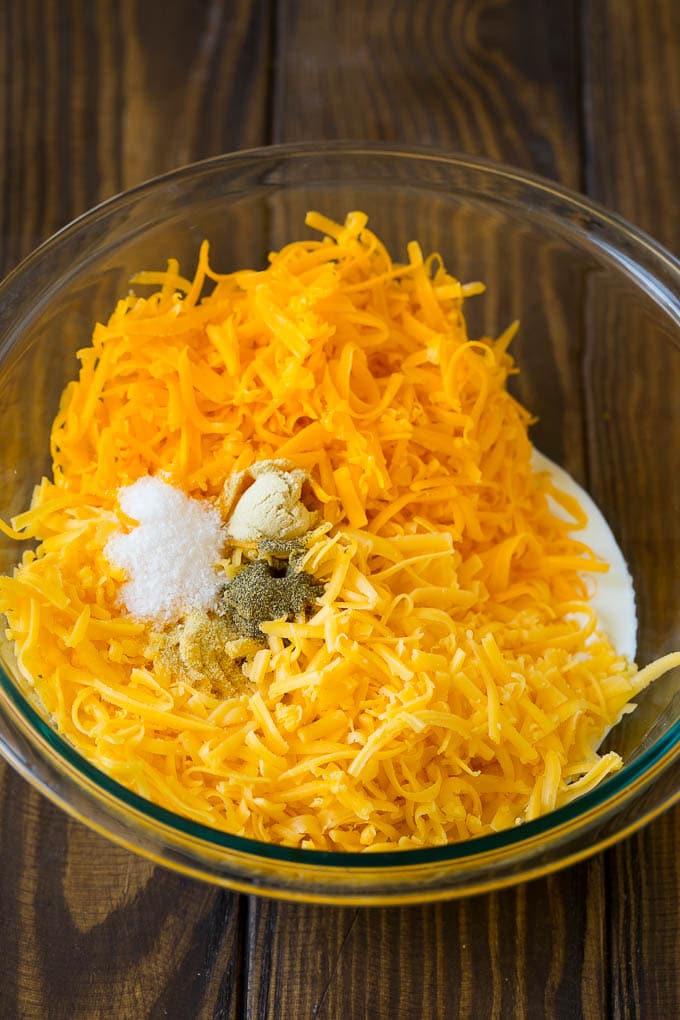 Southern Mac and Cheese | Baked Macaroni and Cheese #pasta #macandcheese #dinner #comfortfood #cheese #sadud A bowl of milk, cream, two types of shredded cheese and seasonings.