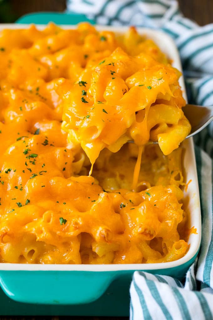 Southern Mac and Cheese | Baked Macaroni and Cheese #pasta #macandcheese #dinner #comfortfood #cheese #sadud A spoon serving up a portion of Southern mac and cheese.