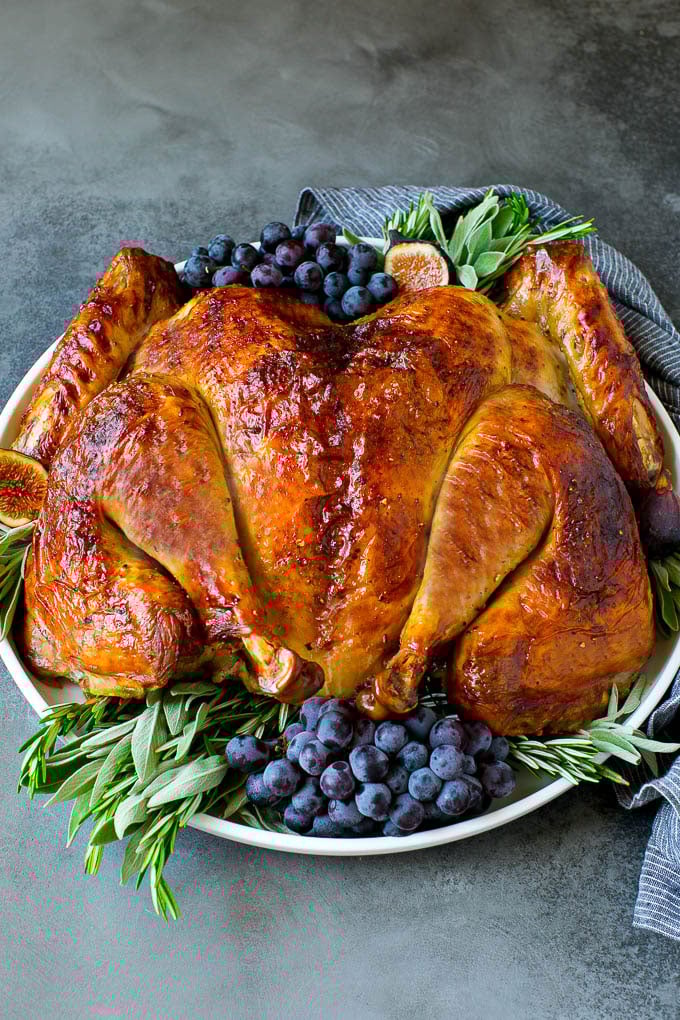 Spatchcock Turkey | Roasted Turkey | Thanksgiving Turkey #turkey #thanksgiving #dinner #fall #christmas #sadud Spatchcock turkey garnished with grapes and fresh herbs.