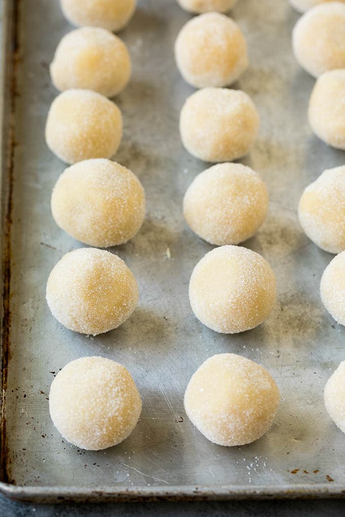 Thumbprint Cookies | Sugar Cookies #cookies #baking #christmas #dessert #sadud Balls of cookie dough rolled in sugar.