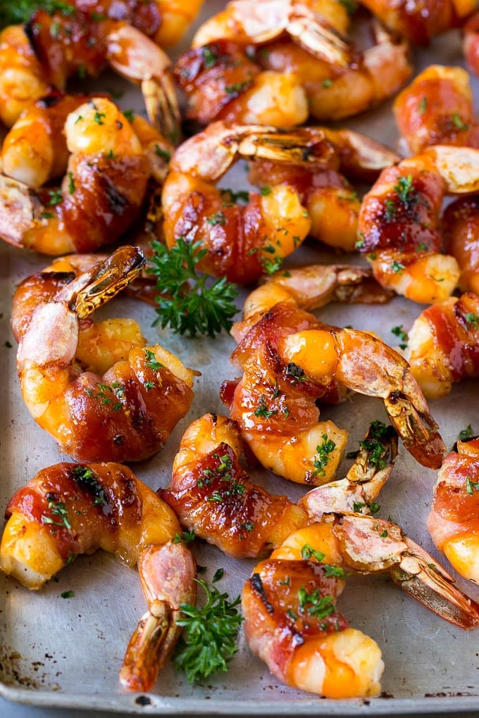 Bacon Wrapped Shrimp Recipe | Bacon Shrimp #shrimp #bacon #appetizer #dinner #sadud #seafood Bacon wrapped shrimp in a sweet and savory glaze, garnished with parsley.