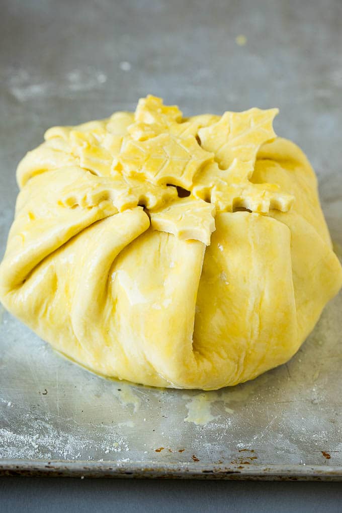 Baked Brie Recipe | Pastry Wrapped Brie #brie #cheese #appetizer #pecans #raspberries #sadud Cheese wrapped in puff pastry and topped with egg wash.