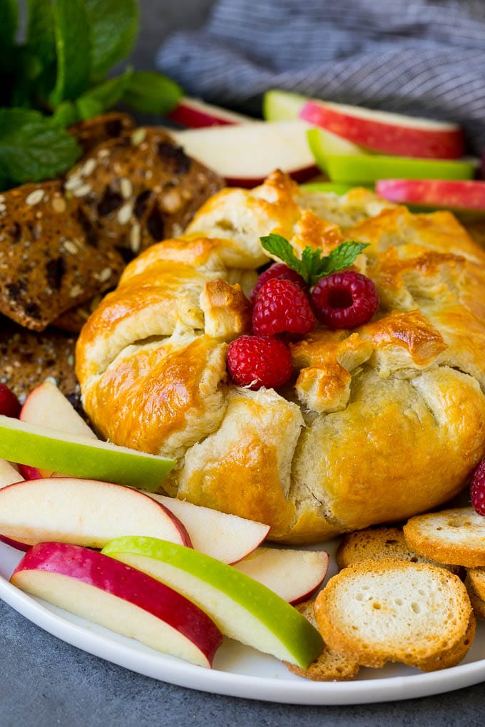 Baked Brie Recipe | Pastry Wrapped Brie #brie #cheese #appetizer #pecans #raspberries #sadud Brie wrapped in puff pastry, served with apples and crackers.