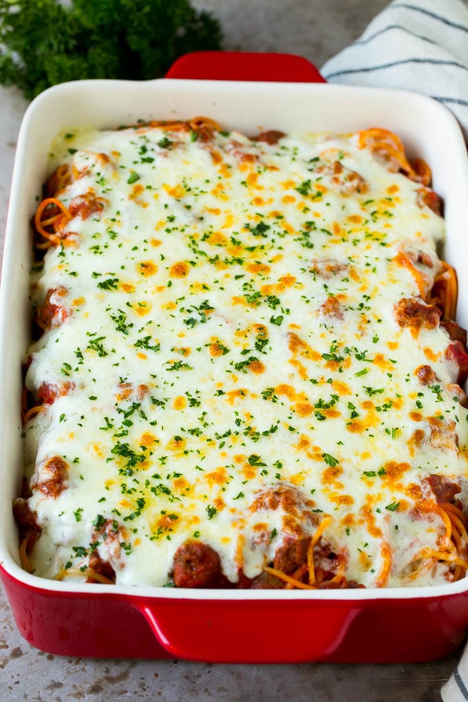 Baked Spaghetti Recipe | Baked Pasta #spaghetti #pasta #cheese #casserole #beef #sausage #dinner #sadud Spaghetti in a baking dish with melted cheese baked on top.