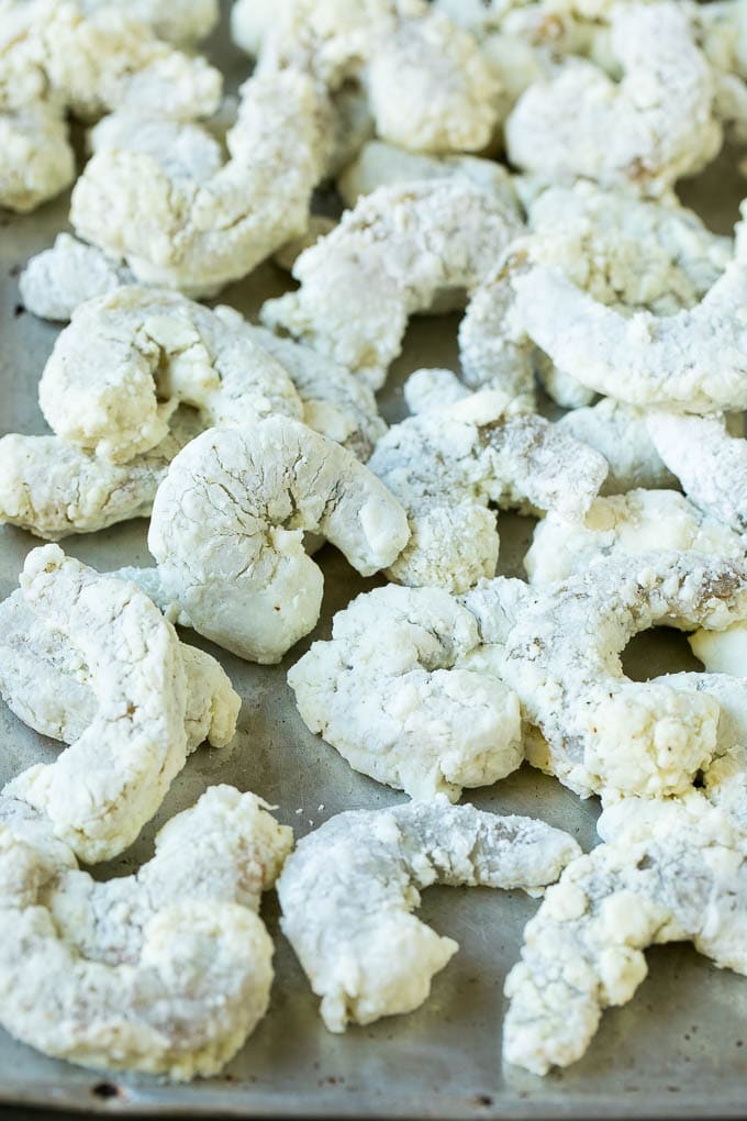 Bang Bang Shrimp Recipe | Fried Shrimp #shrimp #appetizer #dinner #sadud #copycatrecipe Shrimp coated in cornstarch on a sheet pan.