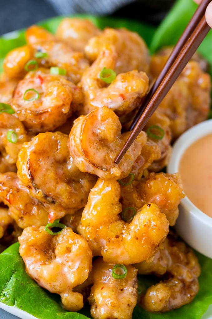 Bang Bang Shrimp Recipe | Fried Shrimp #shrimp #appetizer #dinner #sadud #copycatrecipe A pair of chopsticks picking up bang bang shrimp.