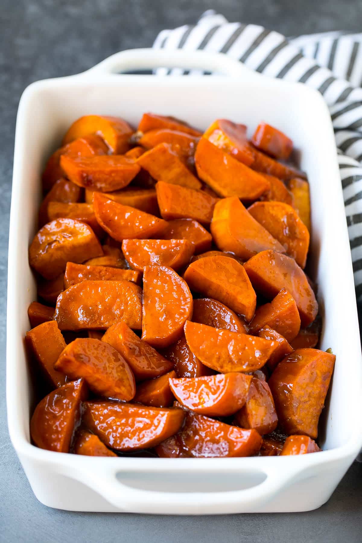 A baking dish filled with yams in a sugar sauce.