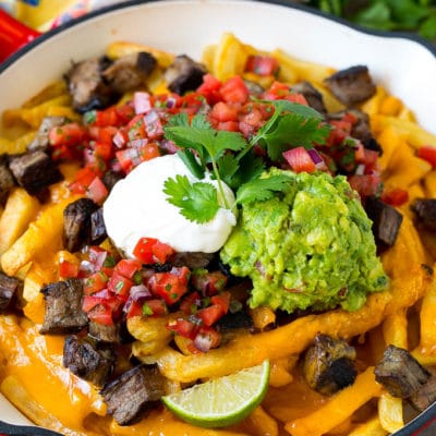Carne asada fries topped with melted cheese, steak, salsa and guacamole.