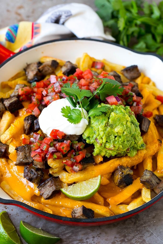 Carne Asada Fries Recipe | Steak Fries #fries #frenchfries #steak #salsa #avocado #cheese #dinner #appetizer #sadud Carne asada fries topped with melted cheese, steak, salsa and guacamole.