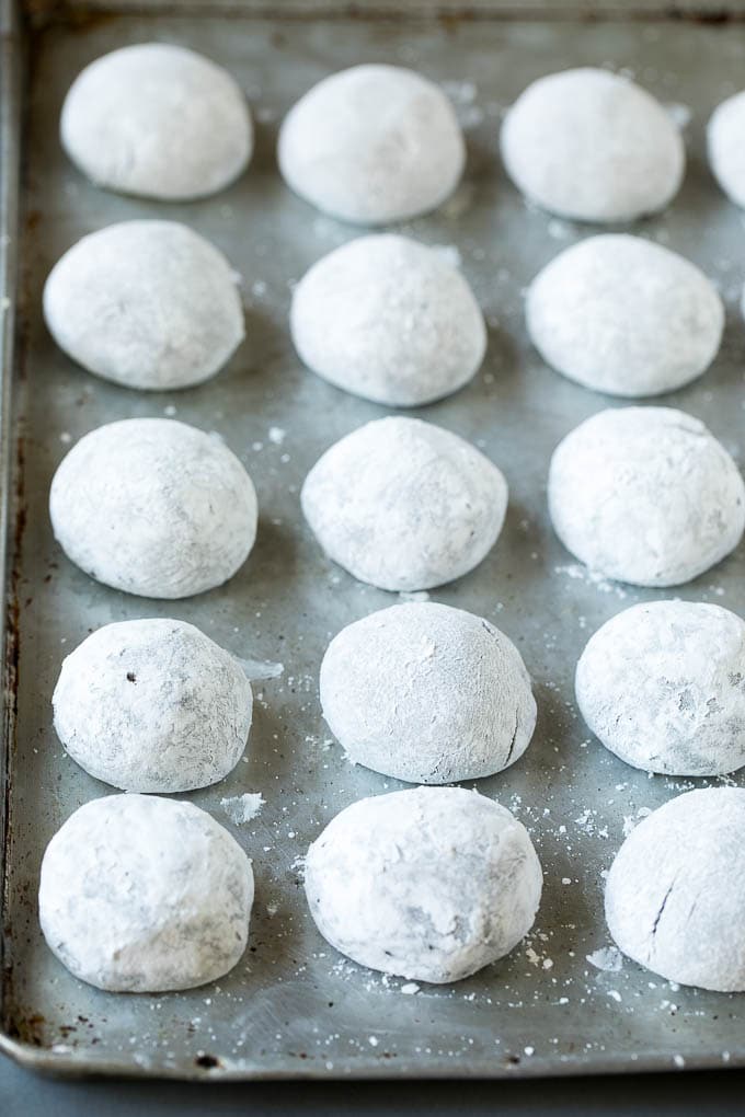 Chocolate Crinkle Cookies Recipe #cookies #chocolate #christmas #dessert #baking #sadud Balls of cookie dough rolled in powdered sugar.