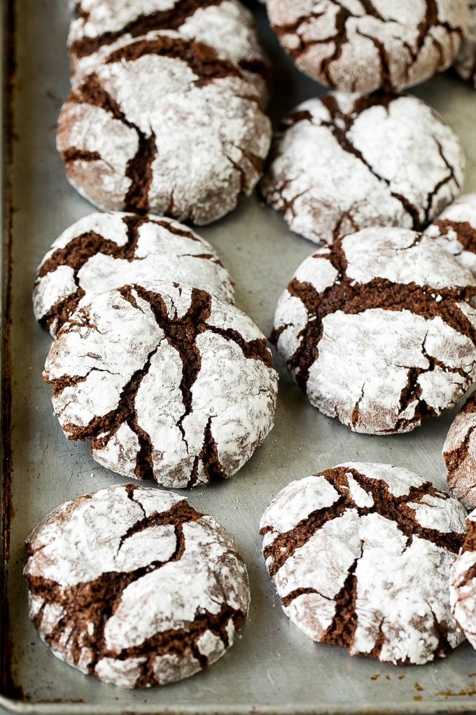 Chocolate Crinkle Cookies Recipe #cookies #chocolate #christmas #dessert #baking #sadud Crinkle cookies on a sheet pan.