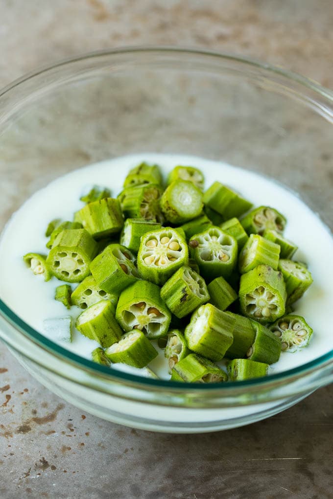 Fried Okra Recipe #okra #appetizer #sidedish #sadud Sliced okra in a bowl of buttermilk.