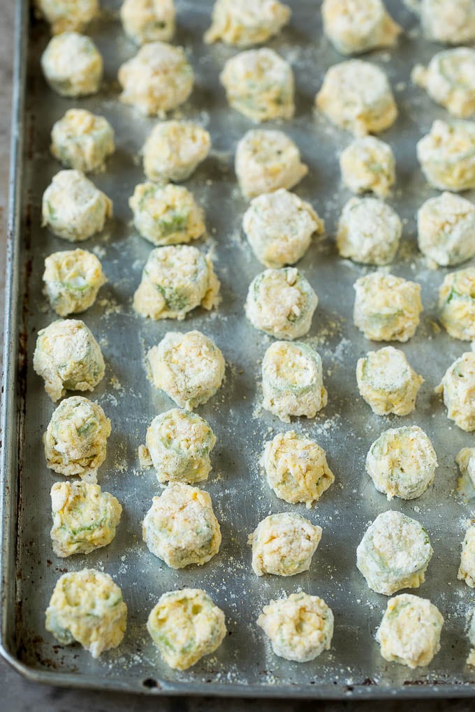 Fried Okra Recipe #okra #appetizer #sidedish #sadud Breaded okra slices on a sheet pan.
