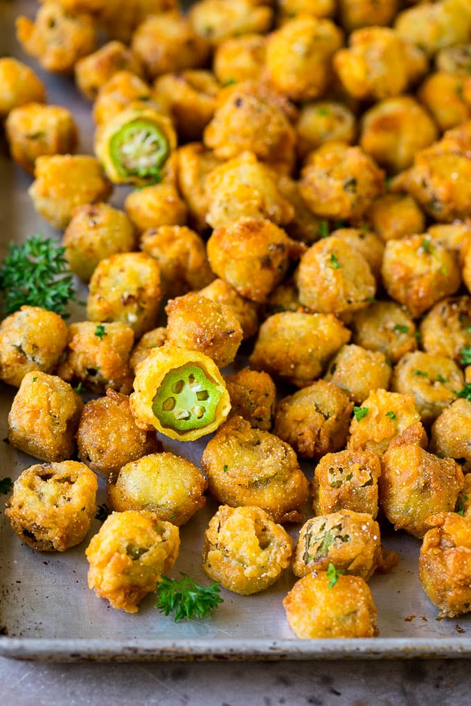 Fried Okra Recipe #okra #appetizer #sidedish #sadud Fried okra on a sheet pan, garnished with chopped parsley.