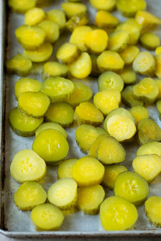 Fried Pickles Recipe #pickles #appetizer #snack #sadud Sliced dills on a sheet pan.