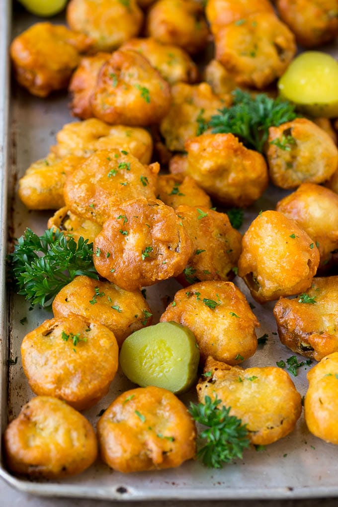 Fried Pickles Recipe #pickles #appetizer #snack #sadud Fried pickles on a sheet pan, garnished with parsley.