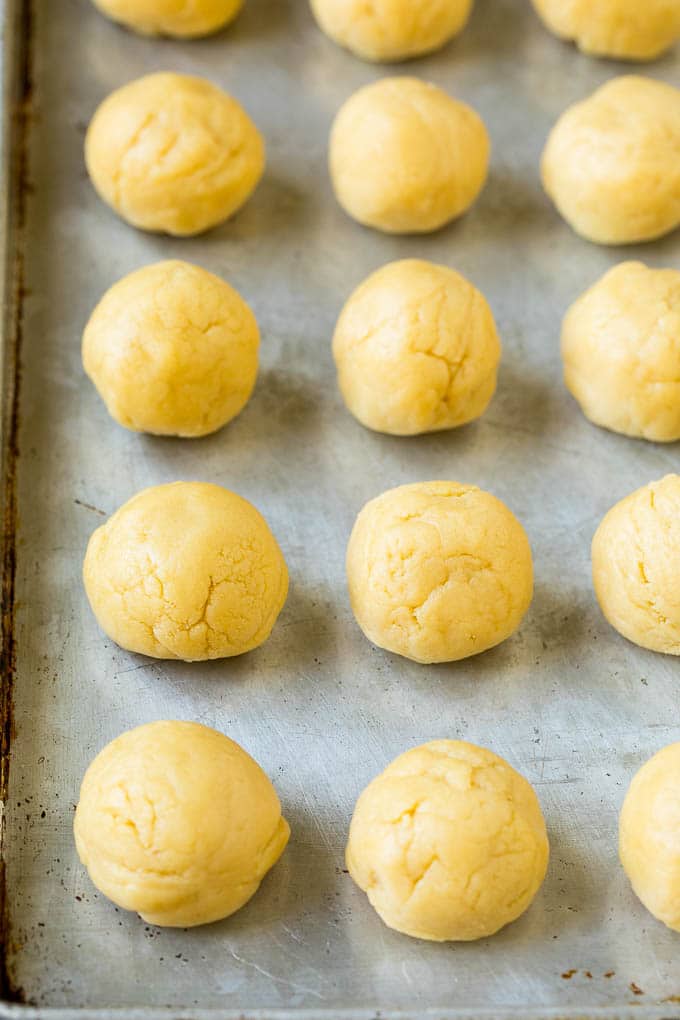 Italian Cookies Recipe | Almond Cookies #cookies #italianfood #frosting #sprinkles #baking #christmas #sadud Balls of cookie dough on a sheet pan.