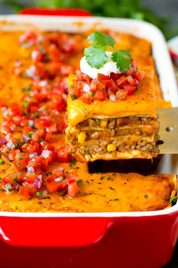 Mexican Lasagna Recipe | Mexican Casserole #mexican #lasagna #groundbeef #beans #dinner #cheese #sadud A spatula serving up a portion of Mexican lasagna.