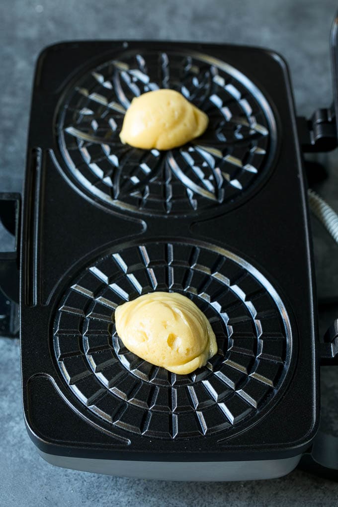 Pizzelle Cookies Recipe #cookies #baking #dessert #christmas #sadud Dollops of dough in a cookie iron.