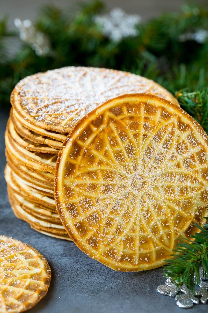 Pizzelle Cookies Recipe #cookies #baking #dessert #christmas #sadud A stack of pizzelle cookies dusted with powdered sugar.
