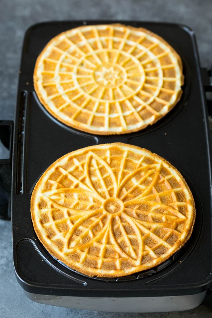 Pizzelle Cookies Recipe #cookies #baking #dessert #christmas #sadud Baked cookies inside a pizzelle iron.