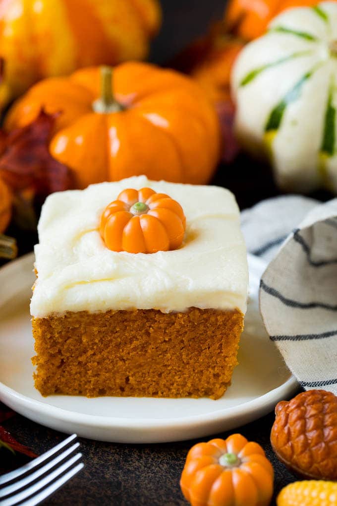 Pumpkin Cake Recipe | Pumpkin Spice Cake #cake #pumpkin #dessert #baking #fall #thanksgiving #sadud A slice of pumpkin cake topped with cream cheese frosting.