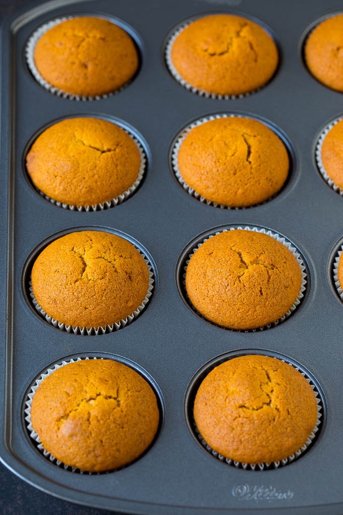 Pumpkin Cupcakes Recipe | Pumpkin Cake #cake #cupcakes #pumpkin #frosting #baking #fall #thanksgiving #sadud Baked cupcakes in a muffin tin.