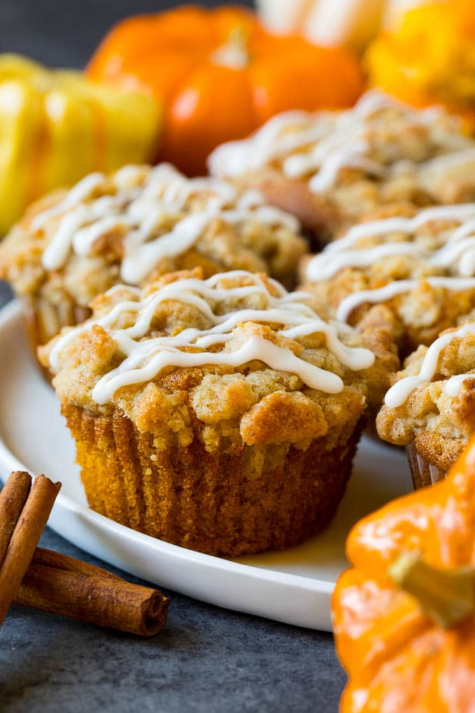 These pumpkin muffins are light and tender treats filled with plenty of pumpkin puree and spice, then topped with brown sugar streusel and baked to perfection. A plate of pumpkin streusel muffins.