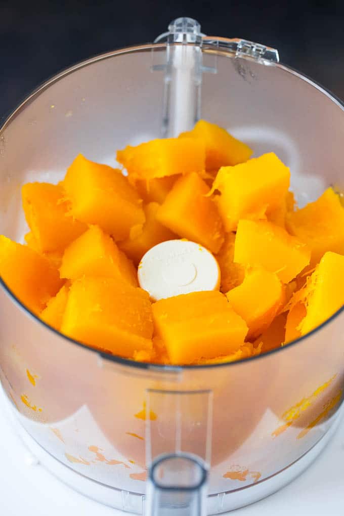Pumpkin Puree Recipe #pumpkin #baking #fall #thanksgiving #sadud Cubes of pumpkin in a food processor.