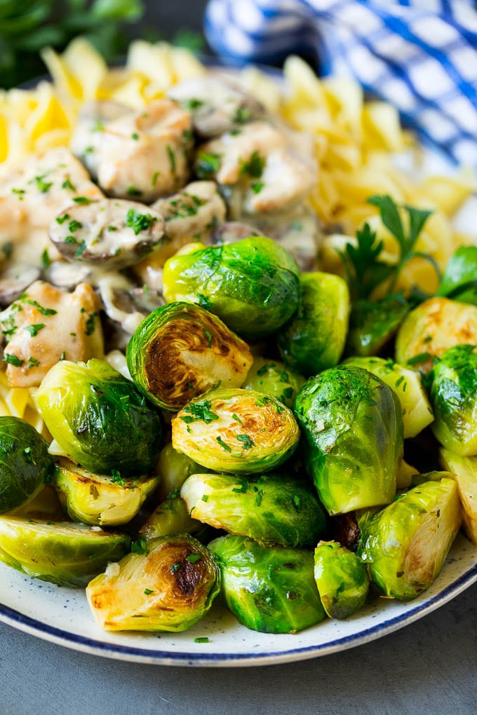 Sauteed Brussels Sprouts Recipe | Brussels Sprouts Side Dish #brusselssprouts #sprouts #veggies #sidedish #garlic #vegetarian #dinner #sadud Sauteed brussels sprouts served alongside chicken and noodles.
