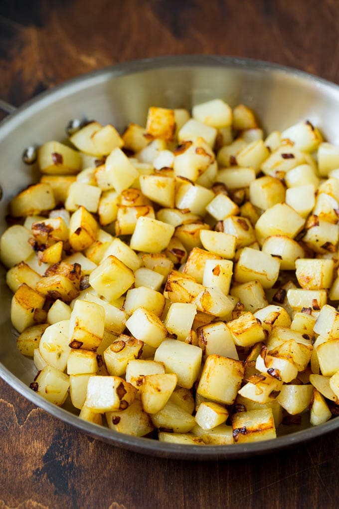 Corned Beef Hash Recipe #hash #cornedbeef #stpatricksday #breakfast #brunch #potatoes #sadud Sauteed potatoes in a skillet.