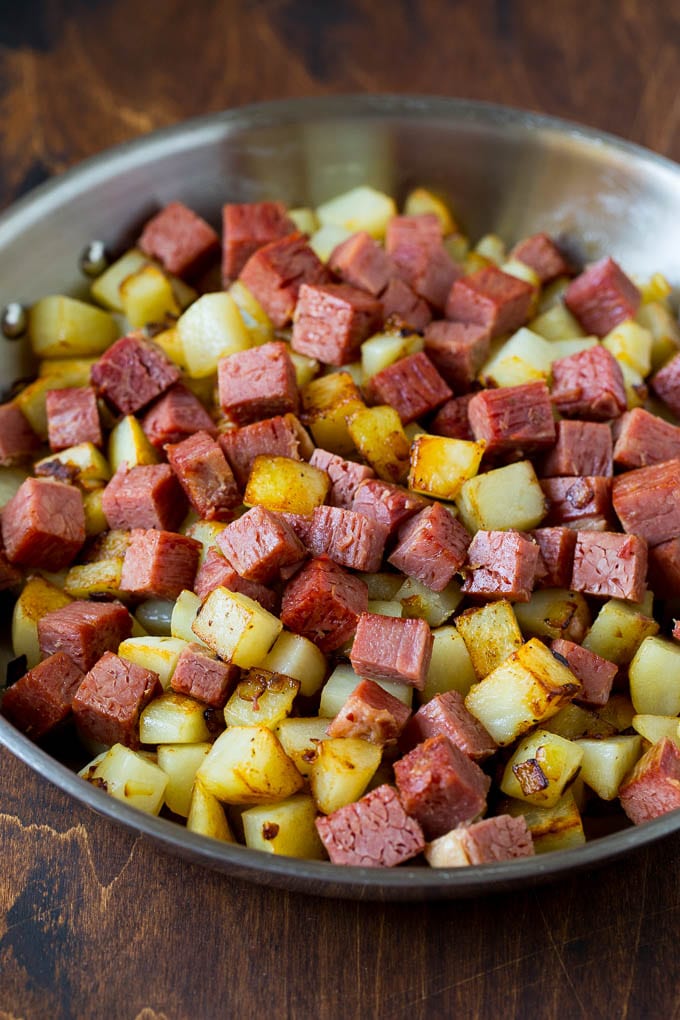 Corned Beef Hash Recipe #hash #cornedbeef #stpatricksday #breakfast #brunch #potatoes #sadud Corned beef and potatoes cooked together in a pan.
