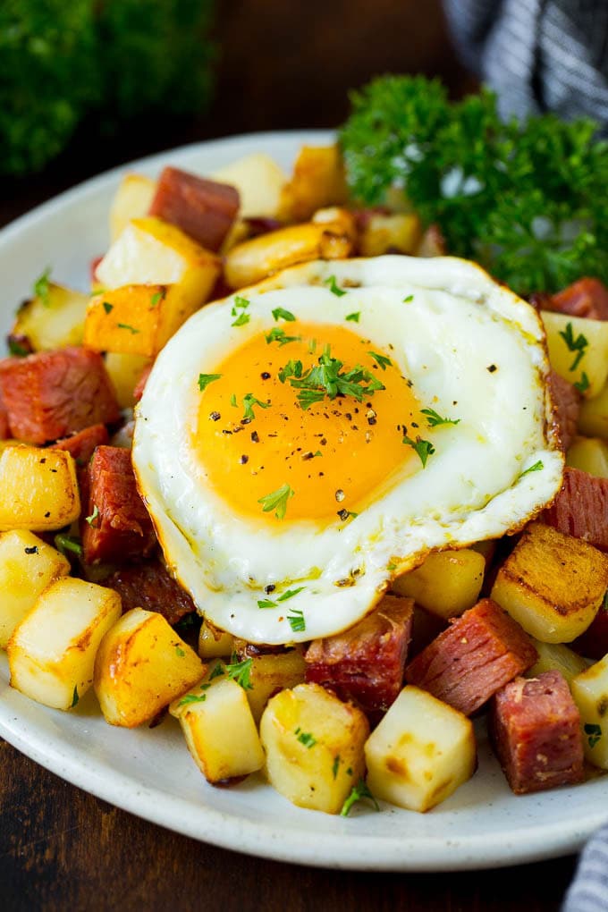 Corned Beef Hash Recipe #hash #cornedbeef #stpatricksday #breakfast #brunch #potatoes #sadud A plate of corned beef hash topped with a fried egg.