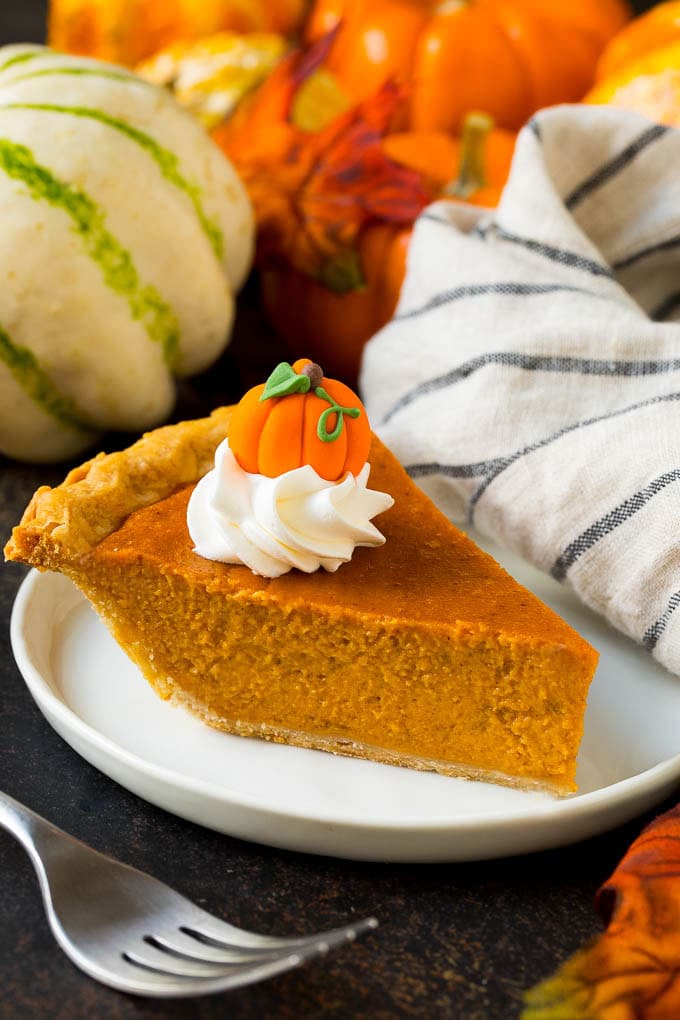 Homemade Pumpkin Pie Recipe | Pumpkin Pie #pie #pumpkin #baking #thanksgiving #fall #dessert #sadud A slice of homemade pumpkin pie topped with whipped cream and a candy pumpkin.