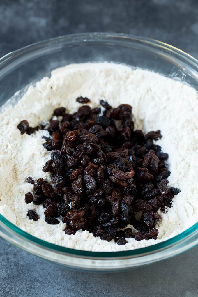 Irish Soda Bread Recipe #bread #baking #stpatricksday #sidedish #sadud Flour, sugar, butter, baking powder and raisins in a mixing bowl.
