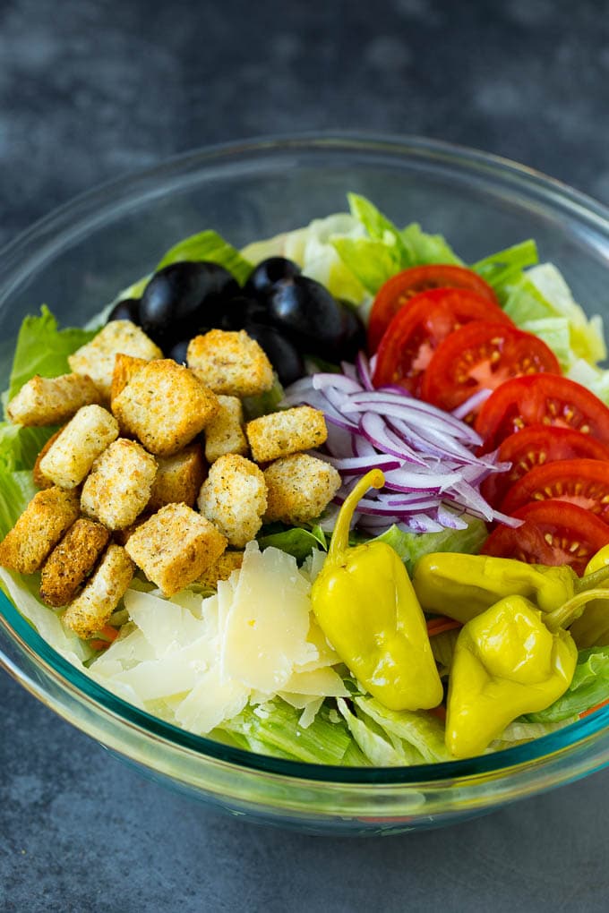 Olive Garden Salad Recipe | Italian Salad #salad #lettuce #olives #sidedish #dinner #sadud Lettuce, vegetables, olives and croutons in a bowl.