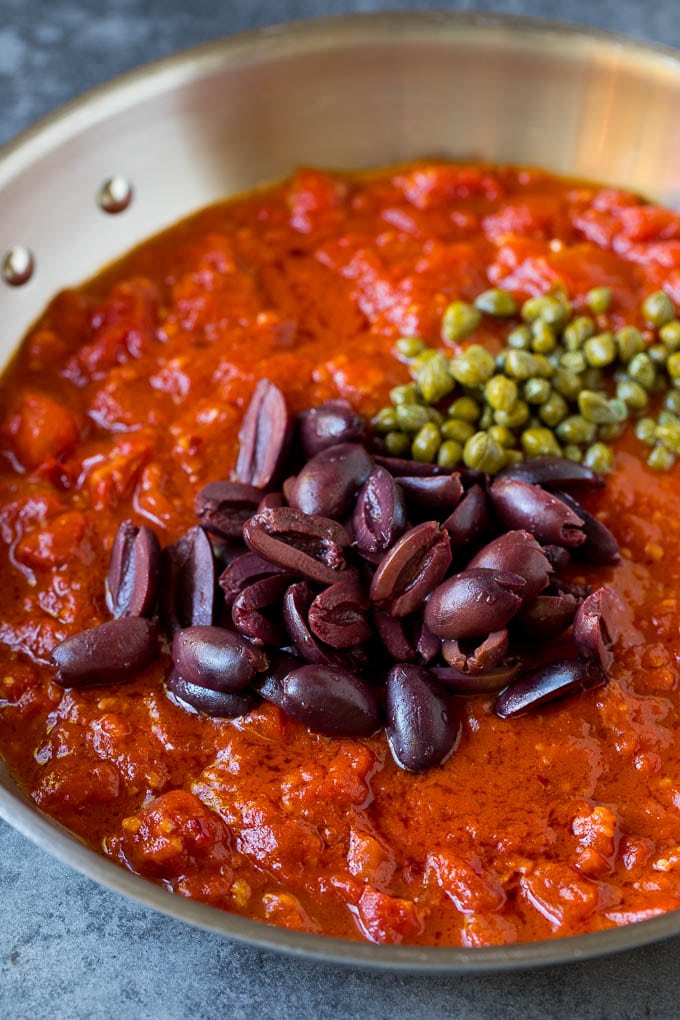 Pasta Puttanesca Recipe #pasta #tomatoes #olives #italianfood #dinner #sadud Tomato sauce with olives and capers on top.