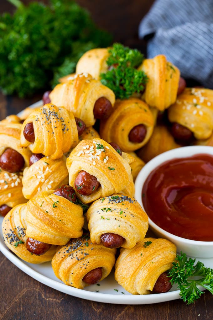 Pigs in a Blanket Recipe #hotdogs #appetizer #snack #comfortfood #sadud A plate of pigs in a blanket served with ketchup.