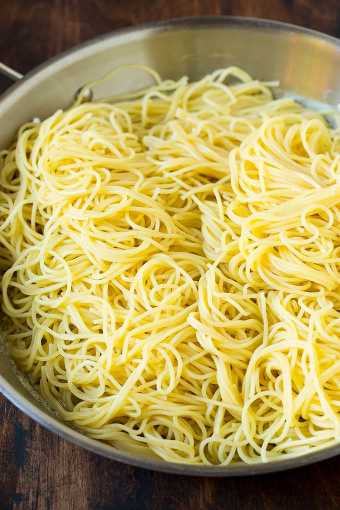Garlic and Herb Angel Hair Pasta #pasta #garlic #sidedish #dinner #sadud Pasta in a pan with garlic and butter.