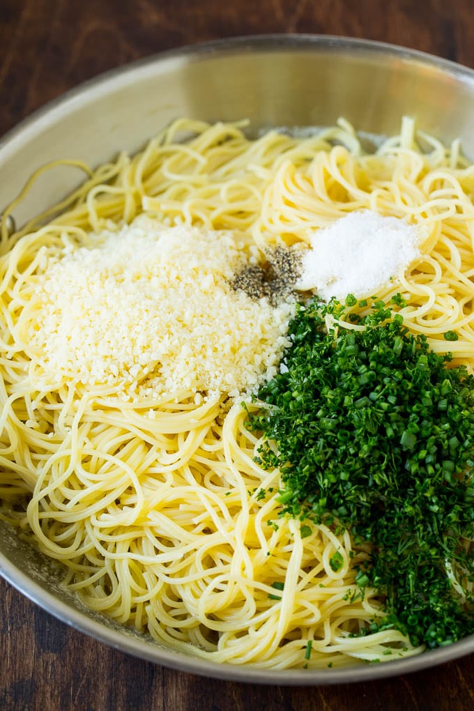 Garlic and Herb Angel Hair Pasta #pasta #garlic #sidedish #dinner #sadud Pasta topped with herbs, cheese, salt and pepper.