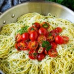 Garlic and herb angel hair pasta topped with fresh tomatoes.